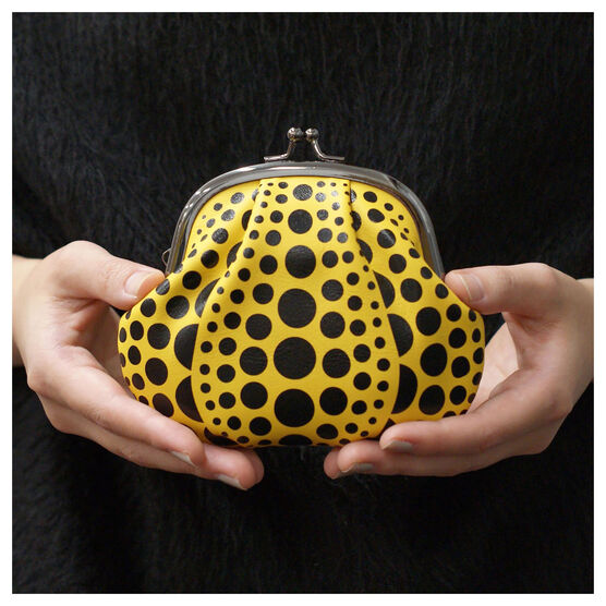 Yellow coin purse with black dots, like a Yayoi Kusama pumpkin artwork